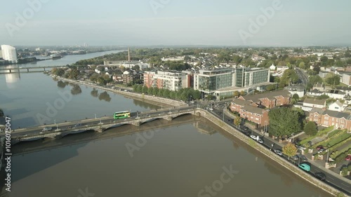 Wallpaper Mural Limerick city and river at dawn with a bridge and light morning traffic crossing, aerial view Torontodigital.ca