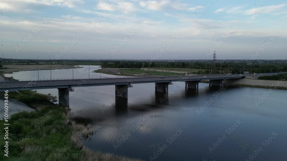 Kostanay, Kazakhstan - 06.04.2024 : A transport bridge over the Tobol River. View of the city. The view from the drone. Kostanay, Kazakhstan - 06.04.2024 : A transport bridge over the Tobol River. View of the city. The view from the drone.