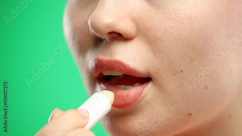 Woman's mouth, close-up, on a green background