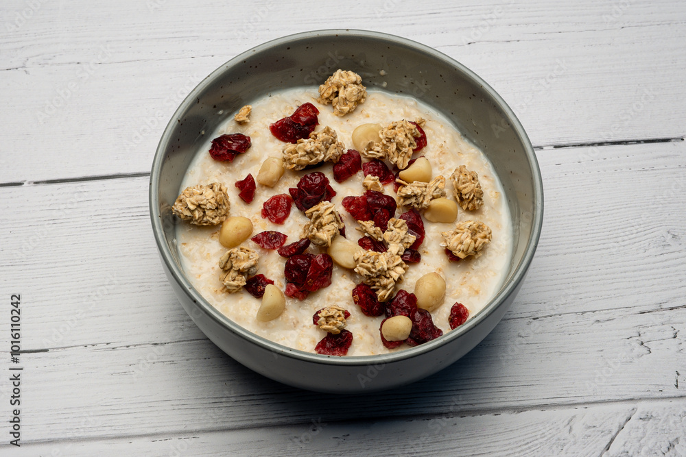 Traditional Scottish breakfast with a modern twist of a bowl of traditional porridge loaded with granola pine nuts and cranberries. Traditional Scottish breakfast with a modern twist of a bowl of traditional porridge loaded with granola pine nuts and cranberries.