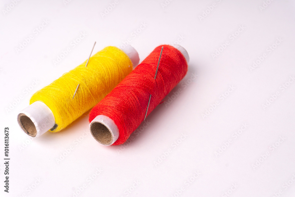 Colorful sewing thread set and needles isolated on background. Colorful sewing thread set and needles isolated on background.