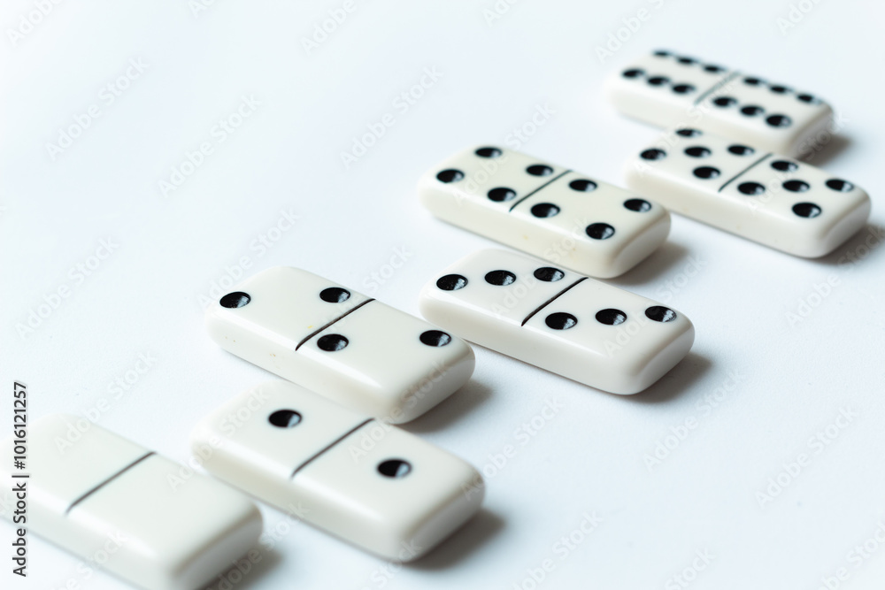 The game of dominoes is a table game involving rectangular pieces with dots that represent numbers. The objective is to match tiles with matching numbers. Photo with white background. The game of dominoes is a table game involving rectangular pieces with dots that represent numbers. The objective is to match tiles with matching numbers. Photo with white background.