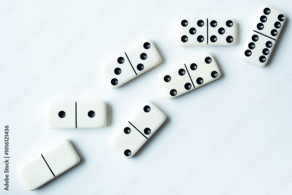 The game of dominoes is a table game involving rectangular pieces with dots that represent numbers. The objective is to match tiles with matching numbers. Photo with white background. The game of dominoes is a table game involving rectangular pieces with dots that represent numbers. The objective is to match tiles with matching numbers. Photo with white background.