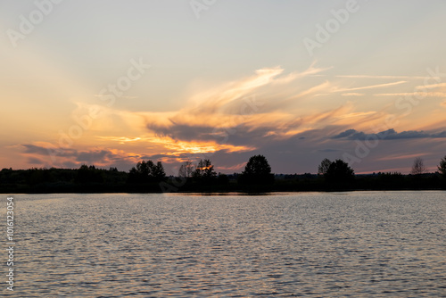 beautiful bright sunset on the lake in the summer