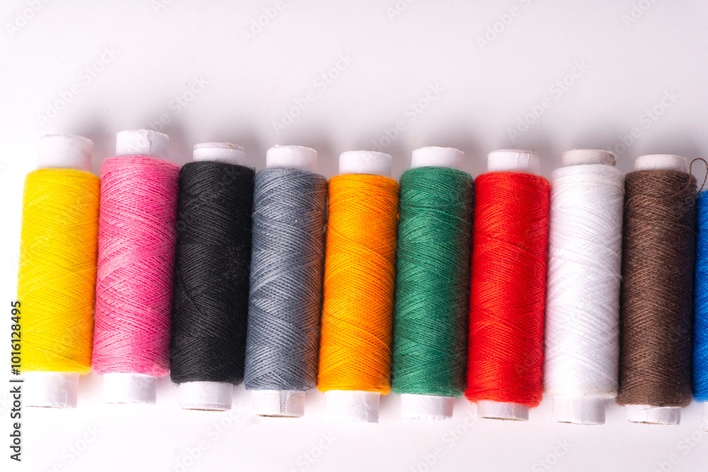 Colorful sewing thread set and needles isolated on background. Colorful sewing thread set and needles isolated on background.