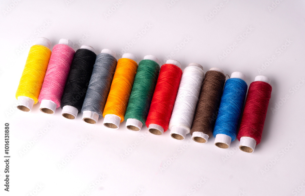 Colorful sewing thread set and needles isolated on background. Colorful sewing thread set and needles isolated on background.