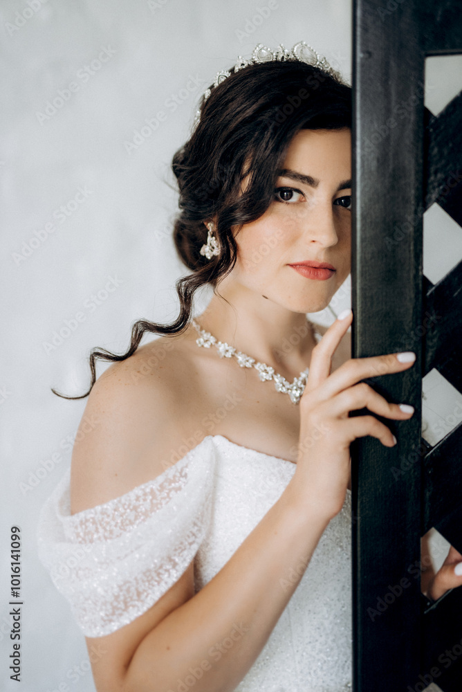 black-haired bride girl getting ready for groom in boudoir
