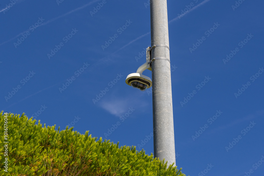 Security camera observing surrounding environment on blue sky Security camera observing surrounding environment on blue sky