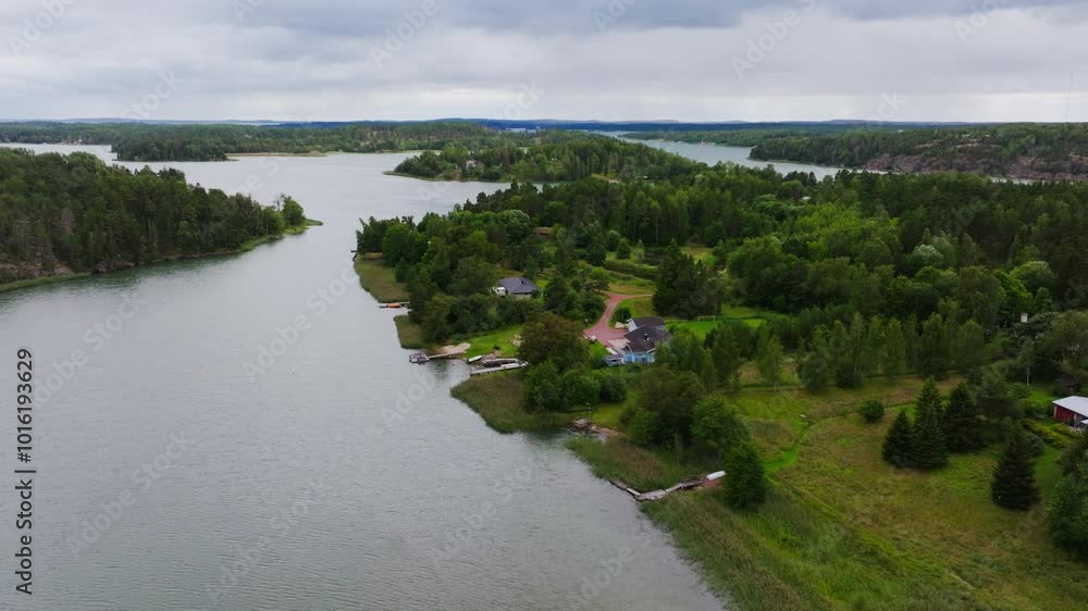 Aerial camera panning over a waterfront property with houses and outbuildings on Aland, an archipelago of islands in Finland Aerial camera panning over a waterfront property with houses and outbuildings on Aland, an archipelago of islands in Finland