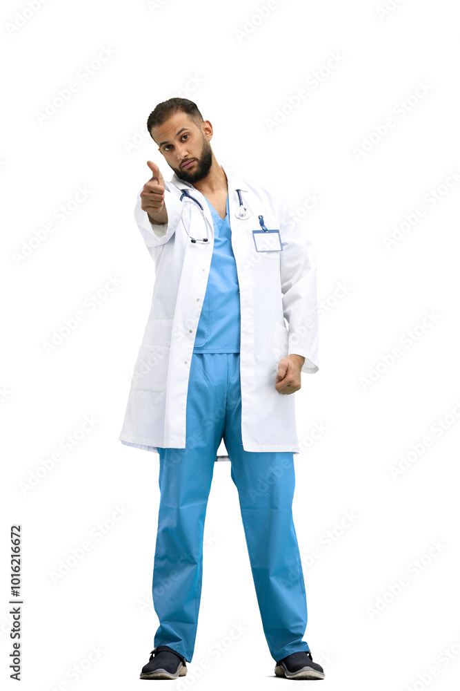 The doctor, in full height, on a white background, shows his thumbs up The doctor, in full height, on a white background, shows his thumbs up