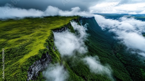 A dramatic scene of a steep cliff covered with lush green vegetation, with clouds rolling over its edge, creating an awe-inspiring and mystical atmosphere.