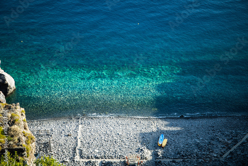 Fotografie View form above of the crystal clear waters and volcanic stone beach of Spiaggia Dello Scario beach in Salina, Aeolian Islands