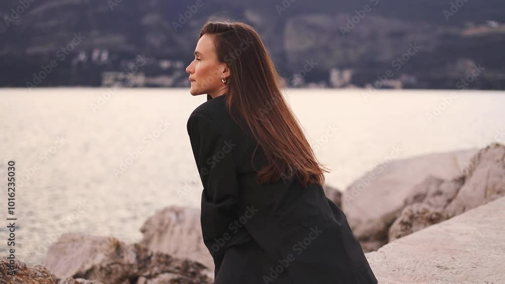 Woman sitting and enjoying of sunset, landscape, sea and mountains. Business woman in jacket deep breathe of fresh air, meditating. Happy smiling woman have a good relax time. Woman sitting and enjoying of sunset, landscape, sea and mountains. Business woman in jacket deep breathe of fresh air, meditating. Happy smiling woman have a good relax time.