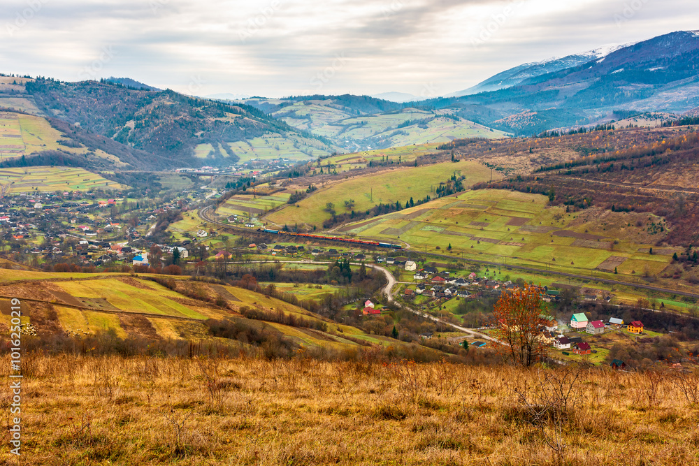 Fototapeta premium rural mountain landscape in november. late autumn scenery with snow capped peaks of carpathian mountains. fall season in ukraine
