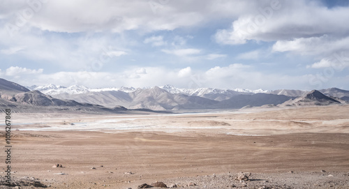 Panoramic landscape of textured Tien Shan mountains in Pamir in Tajikistan, panoramic landscape of a mountain range with snow and glaciers in summer