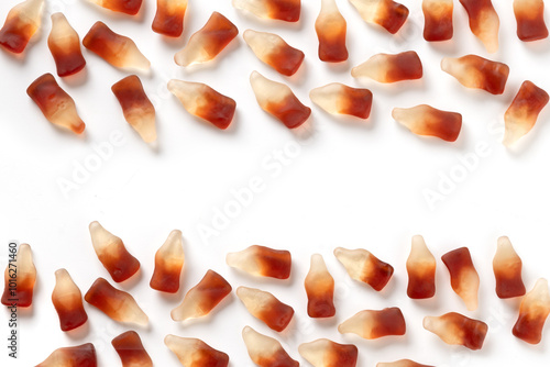 Gummy jellies in shape of soda bottles on white background. View from above. Copy space. photo