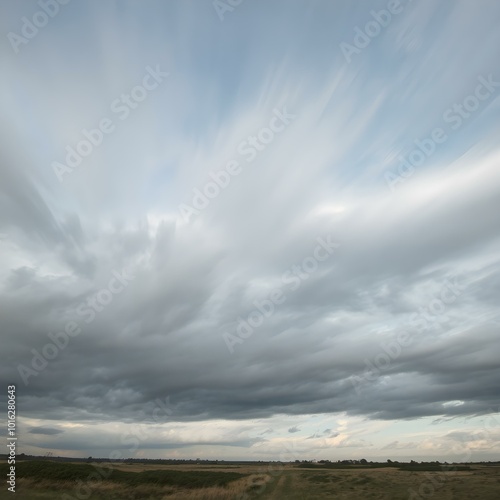 A dynamic sky filled with fast-moving clouds, creating a sense of motion as the wind whips across the landscape 