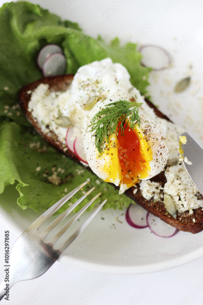 Poached Egg Seasoning with Pepper, Seeds on Plate with Salad Leaves and Radish Slices. Delicious Breakfast. Poached Egg Seasoning with Pepper, Seeds on Plate with Salad Leaves and Radish Slices. Delicious Breakfast.