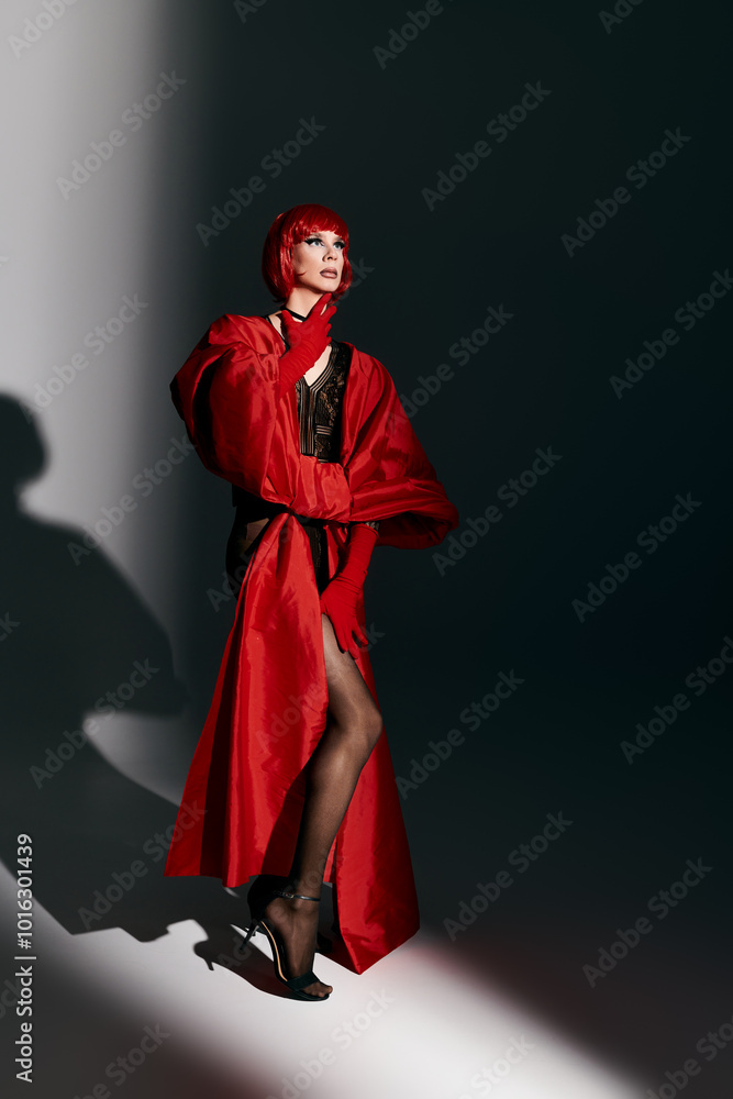 An attractive drag queen showcases confidence and style in a striking red outfit. An attractive drag queen showcases confidence and style in a striking red outfit.