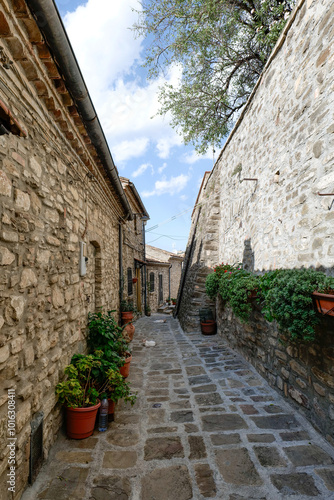 A small street among the old houses of a Guardia Perticara, small town in Basilicata, Italy. photo