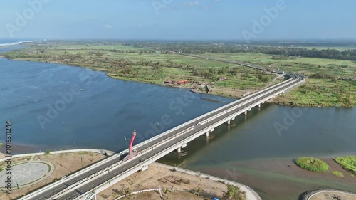 Wallpaper Mural Aerial reveal tilt down view of huge bridge on the big river in Indonesia countryside. Kretek II bridge on Opak River, Yogyakarta, Indonesia. Torontodigital.ca