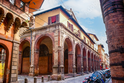 Medieval building with portici - covered walkway in historic center of Bologna, Italy