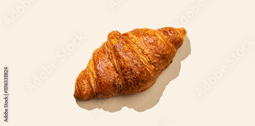 Fresh croissants on yellow  background with shadow. Creative layout and concept of healthy food and french breakfast.