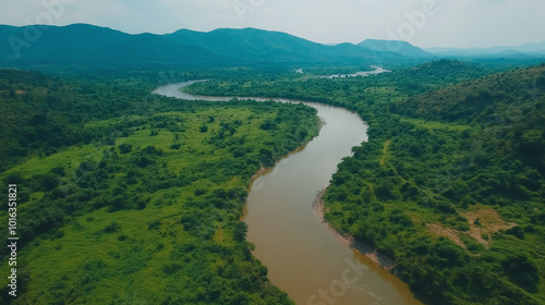 A bird's eye view of a winding river that flows through dense jungle