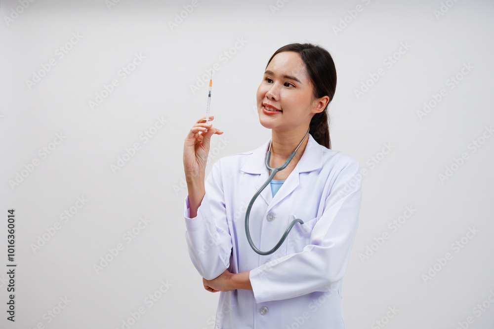 Female doctor in medical gown holding syringe on white background. Female doctor in medical gown holding syringe on white background.