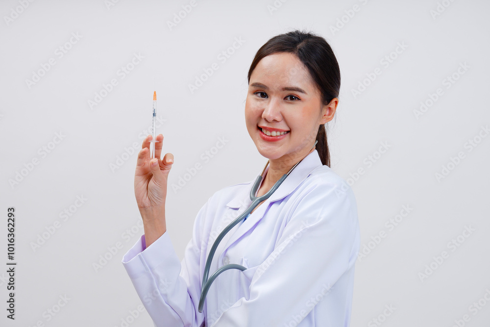 Female doctor in medical gown holding syringe on white background. Female doctor in medical gown holding syringe on white background.