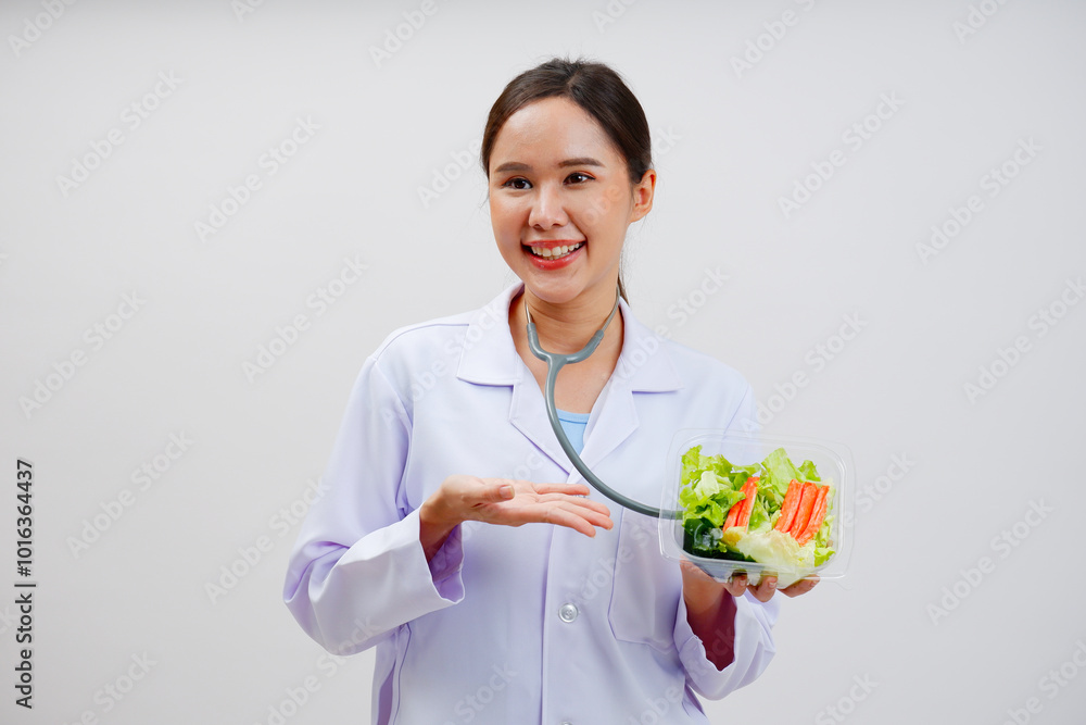 Smiling female doctor holding vegetable salad Health care.