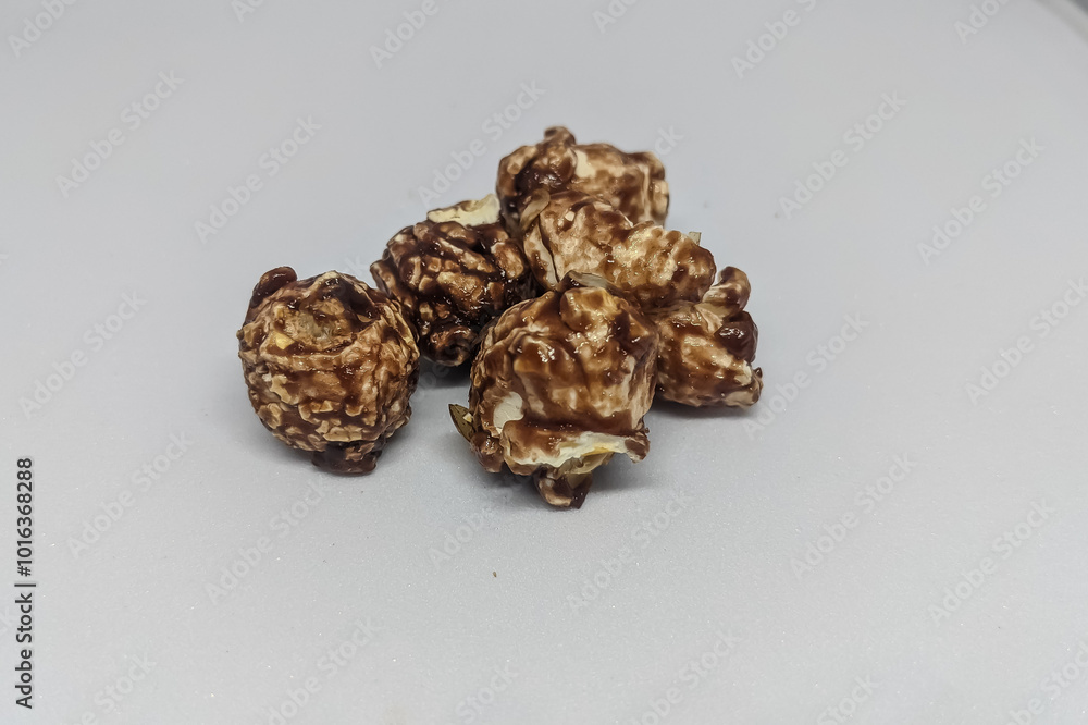 Chocolate popcorn on a white isolated background. toning. selective focus, copy space and clipping path Chocolate popcorn on a white isolated background. toning. selective focus, copy space and clipping path