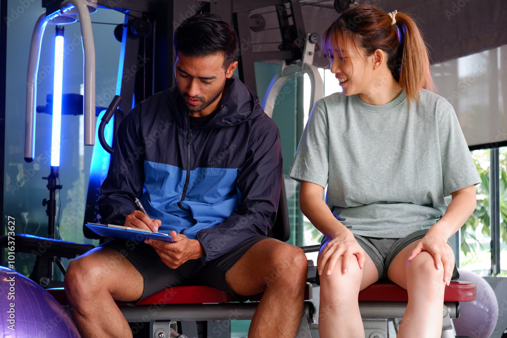 Young woman and man fitness trainers in a gym. Young woman and man fitness trainers in a gym.