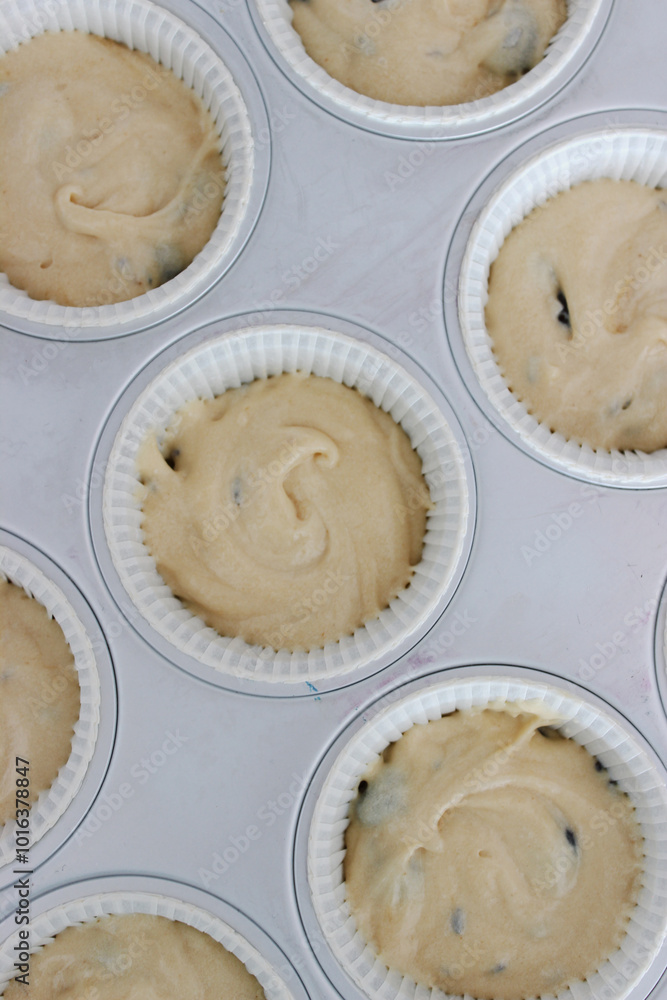 Process of making homemade blueberry muffins with almond crumble and lavender from scratch, close-up top view on baking sheet Process of making homemade blueberry muffins with almond crumble and lavender from scratch, close-up top view on baking sheet
