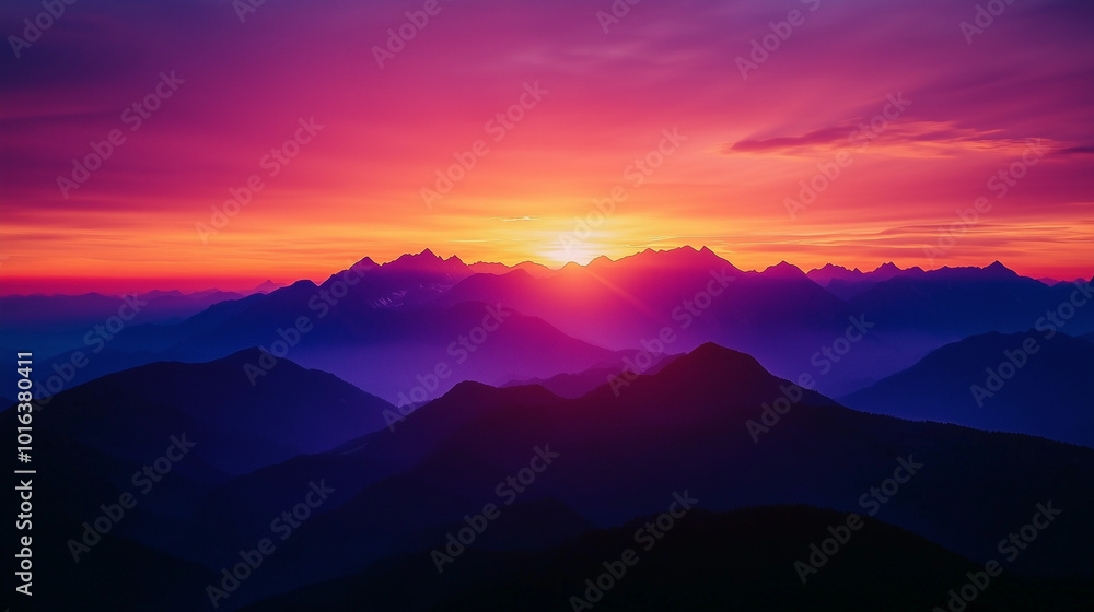 Fototapeta premium Dramatic Sunrise Over Mountain Range with Rich Purple and Orange Hues Filling the Sky