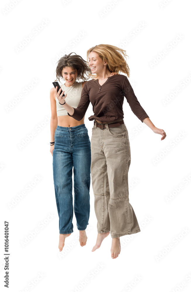 Happy young women using a smartphone and jumping Happy young women using a smartphone and jumping
