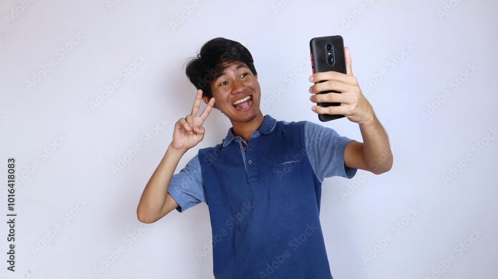 happy asian youth selfie gesture using smartphone camera happy asian youth selfie gesture using smartphone camera