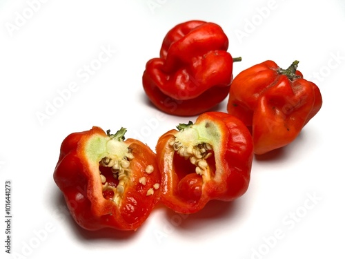 Sliced red hot Habanero chili peppers on a white background, closeup of photo. The Habanero Red chili is an extremely hot pepper with a unique flavor.