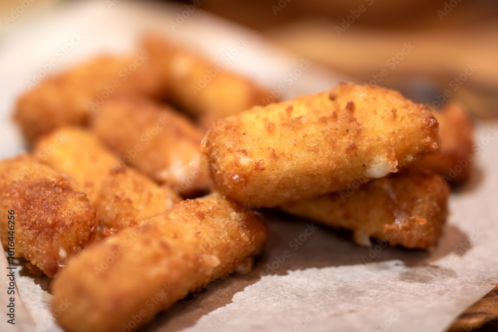 Close up of appetizing fried mozzarella sticks on paper towel Close up of appetizing fried mozzarella sticks on paper towel
