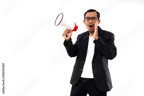 Asian man in casual business suit holding megaphone and yelling. Isolated on white background