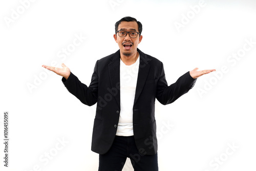 Excited Asian businessman wearing casual suit presenting at the copy space beside him, isolated by white background