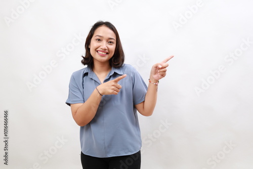 Portrait of smiling young office lady, asian business entrepreneur pointing fingers left, showing client info, chart of banner aside on copy space, white background