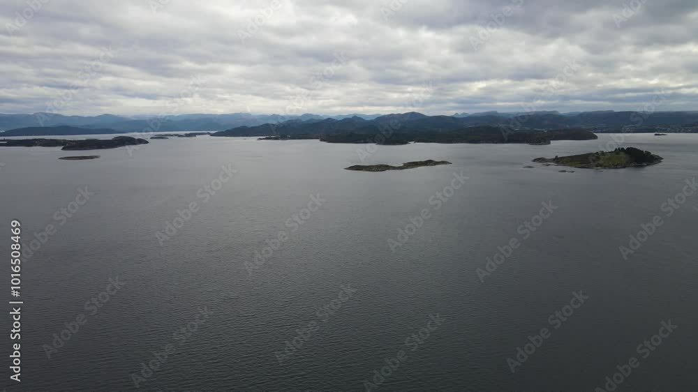 Aerial Drone Shot Over the Ocean with a Mountainous Backdrop Under Overcast Skies in Stavanger, Norway Aerial Drone Shot Over the Ocean with a Mountainous Backdrop Under Overcast Skies in Stavanger, Norway