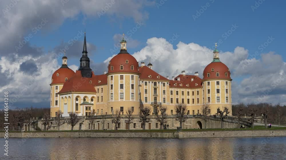 Beautiful famous Moritzburg Castle, castle above lake. Big clouds in sky. Castle is reflected in water. German architecture, Germany Beautiful famous Moritzburg Castle, castle above lake. Big clouds in sky. Castle is reflected in water. German architecture, Germany