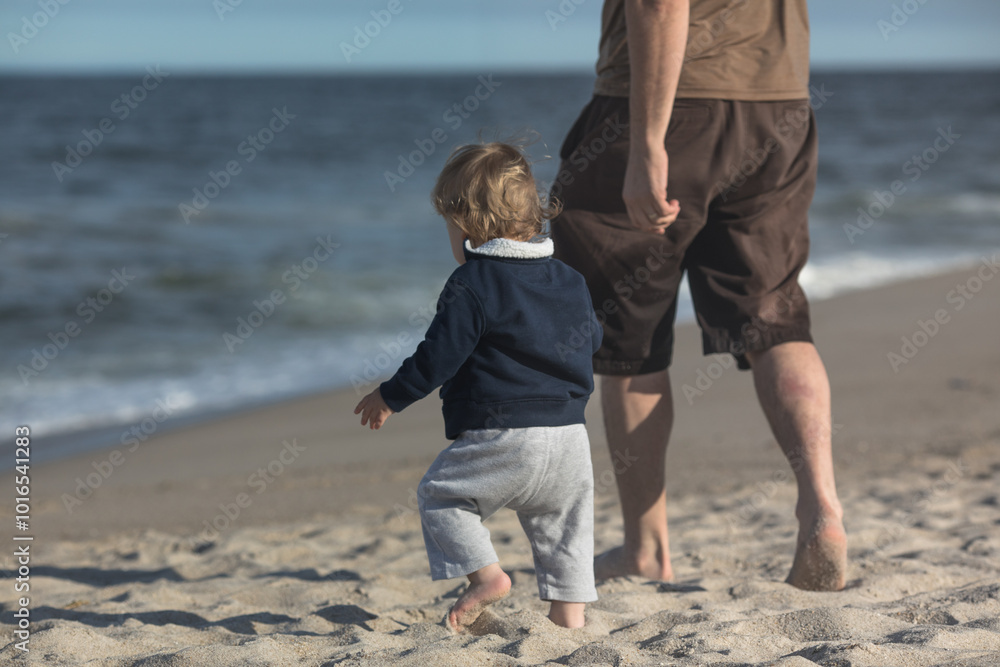 Father and Sons walking on the beach towards the ocean. Positive human emotions feelings emotions. Father and Sons walking on the beach towards the ocean. Positive human emotions feelings emotions.