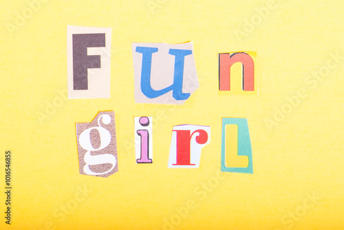 Phrase Fun Girl spelled in cut out newspaper style typography, isolated on yellow background.