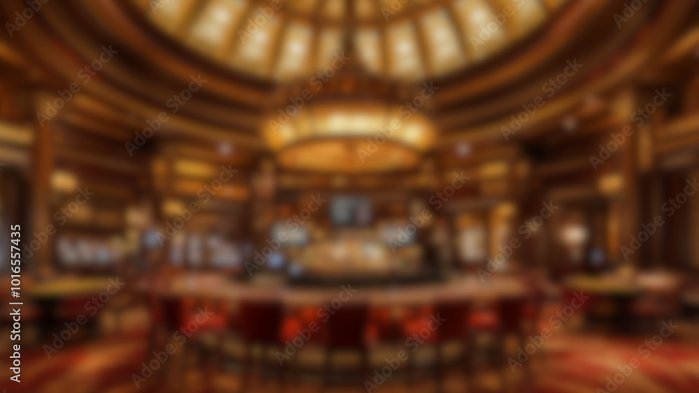 Obraz premium Blurred view of an elegant casino interior with luxurious chandeliers, slot machines, and a bar counter. The warm lighting creates a sophisticated and inviting atmosphere. Ideal for background use. 