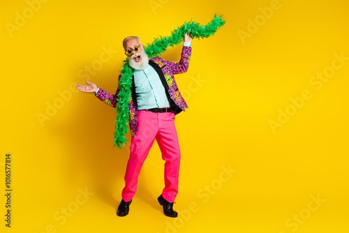 Full body portrait of positive aged man wear pink trousers necklace empty space isolated on yellow color background