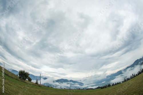 Picturesque view of beautiful mountains covered with fog. Fisheye lens effect