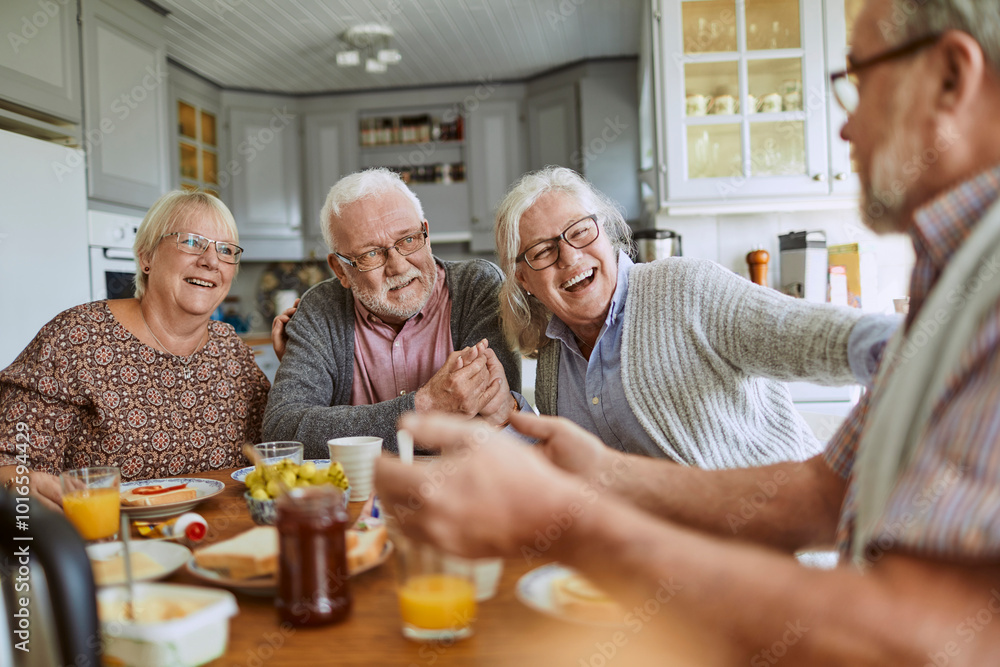 Seniors enjoying breakfast together in cozy kitchen Seniors enjoying breakfast together in cozy kitchen